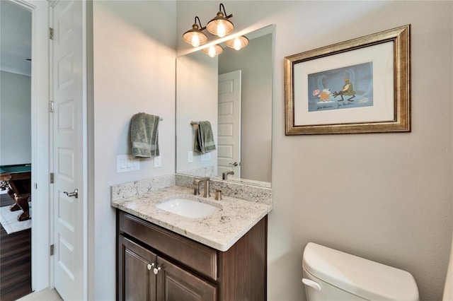 bathroom featuring vanity and toilet