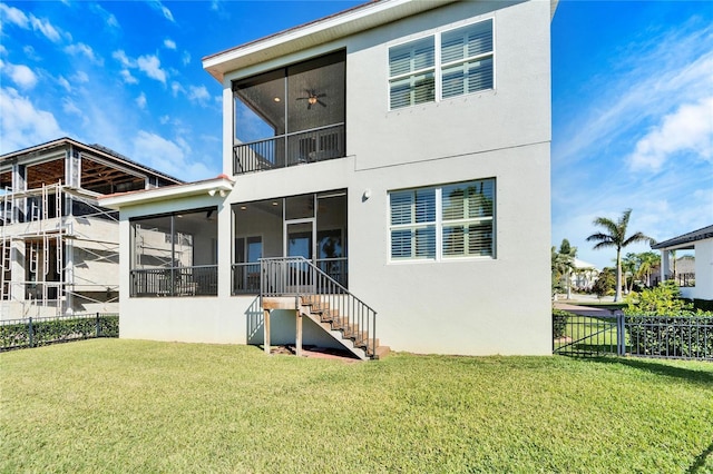 back of property with a lawn and a sunroom