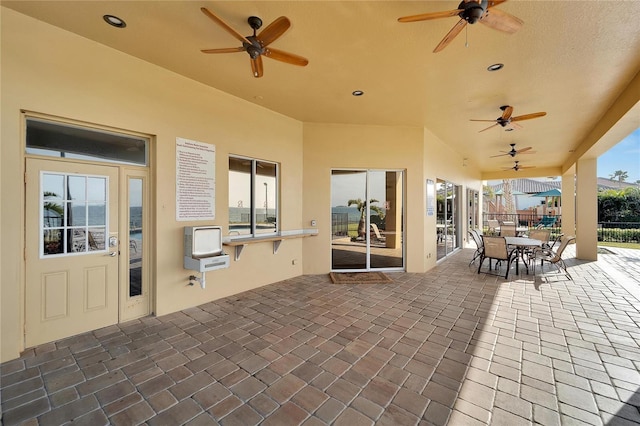 view of patio / terrace with heating unit and a water view