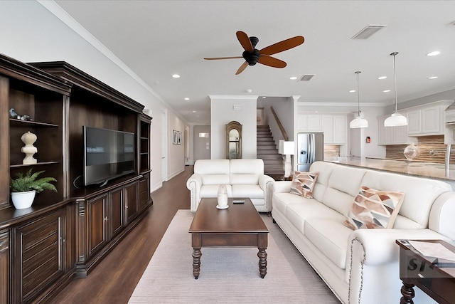 1308 Alhambra Dr, Apollo Beach, FL 33572 - living area featuring dark wood-style floors, ceiling fan, stairway, recessed lighting, and ornamental molding