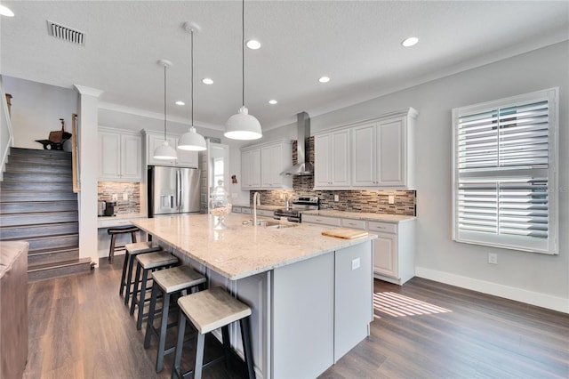 1308 Alhambra Dr, Apollo Beach, FL 33572 - kitchen featuring stainless steel appliances, wall chimney range hood, tasteful backsplash, dark wood finished floors, and recessed lighting