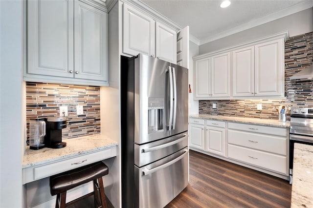 1308 Alhambra Dr, Apollo Beach, FL 33572 - kitchen featuring appliances with stainless steel finishes, backsplash, crown molding, and white cabinets