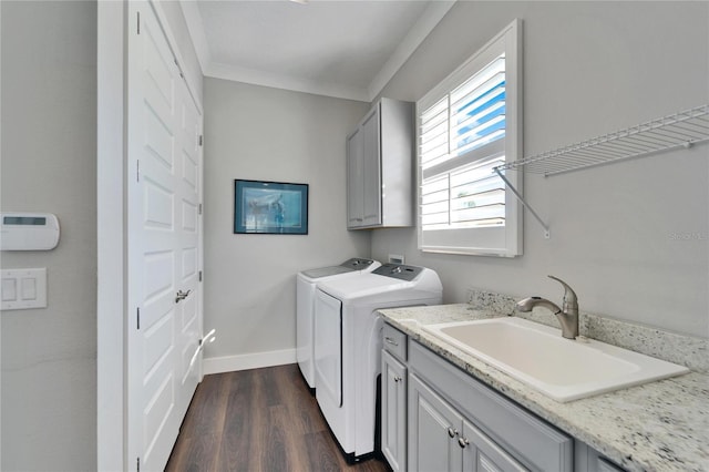 1308 Alhambra Dr, Apollo Beach, FL 33572 - laundry room with cabinet space, washing machine and clothes dryer, dark wood-style flooring, and crown molding