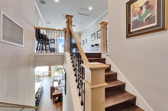 1308 Alhambra Dr, Apollo Beach, FL 33572 - staircase featuring wood finished floors, crown molding, and a towering ceiling