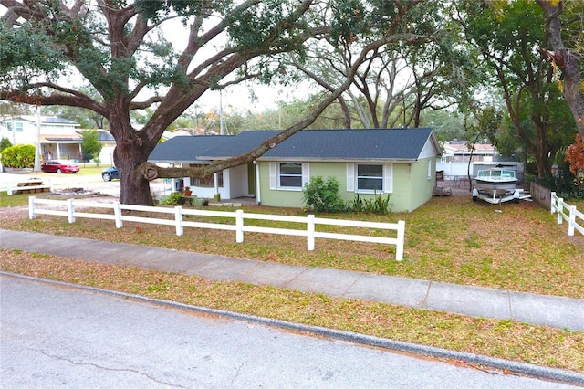 single story home featuring a front yard