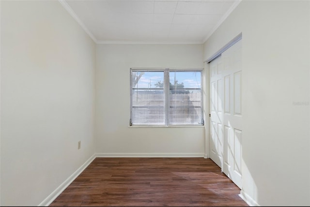 unfurnished room with dark wood-type flooring and ornamental molding