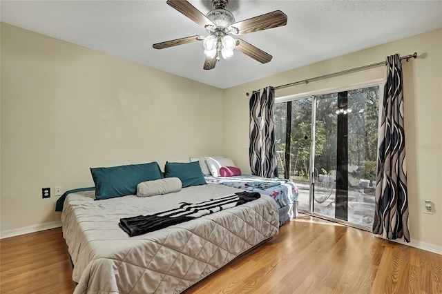 bedroom featuring ceiling fan, access to exterior, and hardwood / wood-style flooring