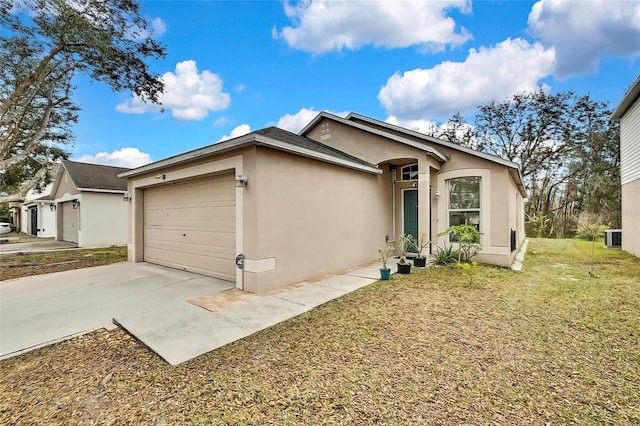 ranch-style home with central AC, a front lawn, and a garage