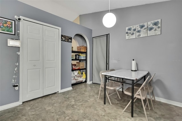 dining area featuring high vaulted ceiling