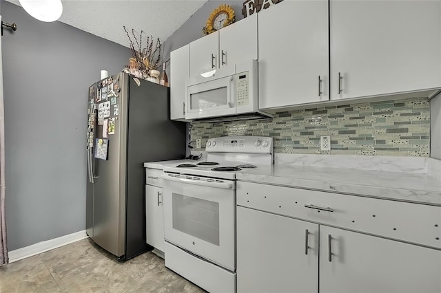 kitchen with white appliances, a textured ceiling, vaulted ceiling, backsplash, and white cabinetry