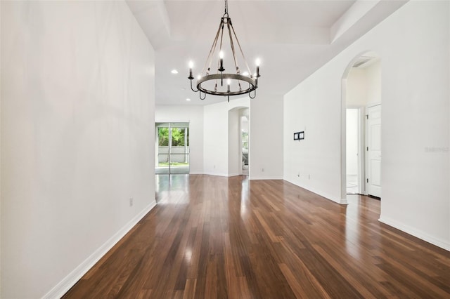 interior space with dark hardwood / wood-style floors and an inviting chandelier