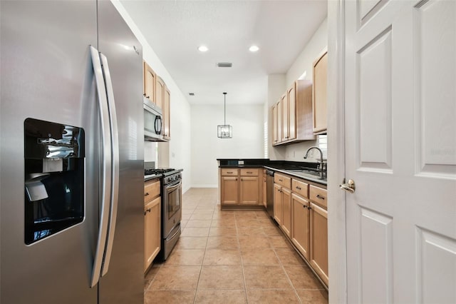 kitchen with light brown cabinets, sink, decorative light fixtures, light tile patterned floors, and appliances with stainless steel finishes