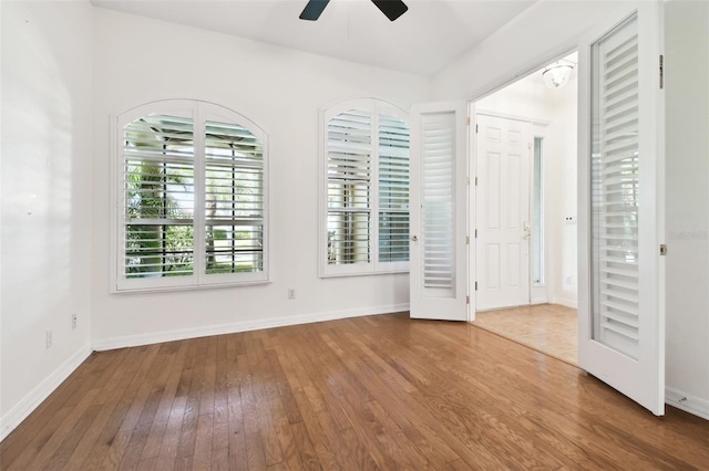 unfurnished room with hardwood / wood-style flooring and ceiling fan