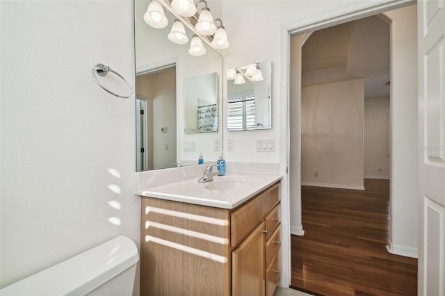 bathroom with vanity, hardwood / wood-style flooring, and toilet