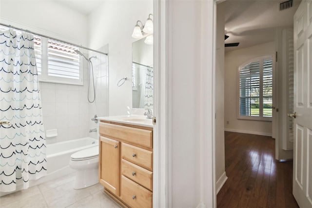 full bathroom with vanity, shower / bath combination with curtain, ceiling fan, toilet, and wood-type flooring