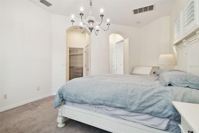 bedroom featuring carpet flooring, an inviting chandelier, a spacious closet, and a closet