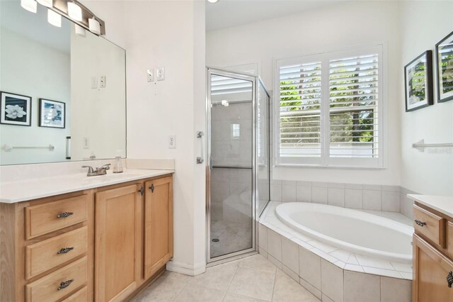 bathroom with tile patterned flooring, vanity, and independent shower and bath