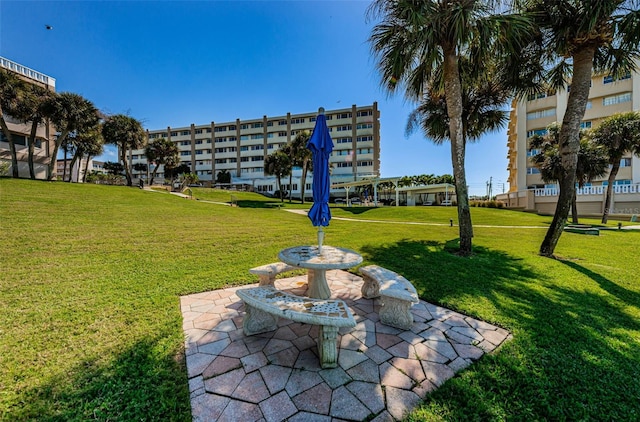 view of community featuring a patio area and a lawn