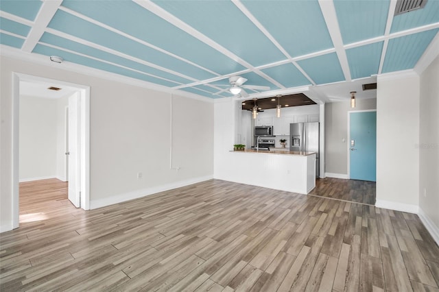 unfurnished living room with a ceiling fan, visible vents, baseboards, and wood finished floors