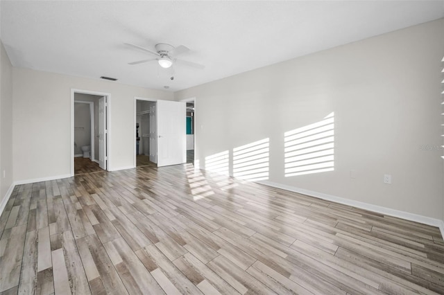 unfurnished room featuring baseboards, a ceiling fan, and wood finished floors