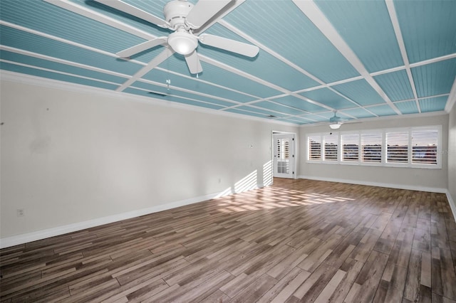 unfurnished room featuring a ceiling fan, visible vents, baseboards, and wood finished floors