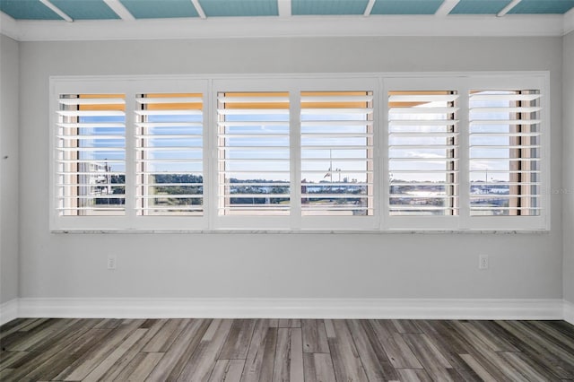 empty room with baseboards and wood finished floors