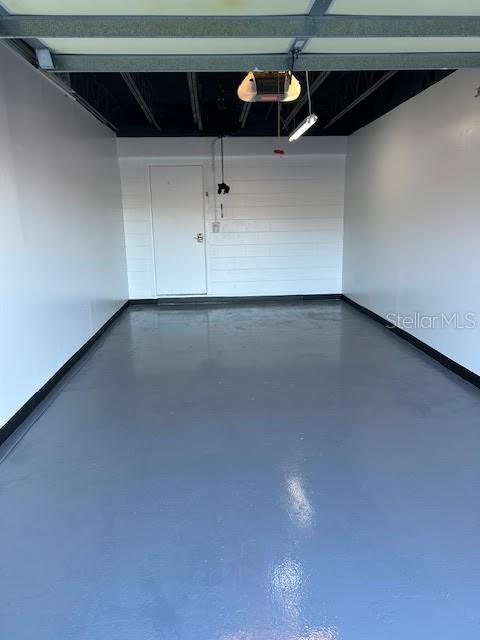 garage featuring baseboards and a garage door opener