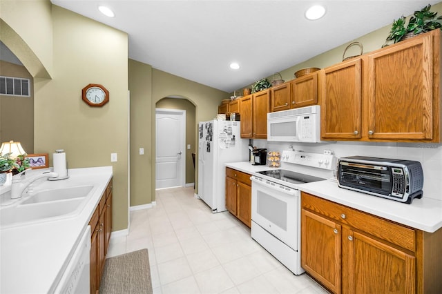 kitchen featuring sink and white appliances