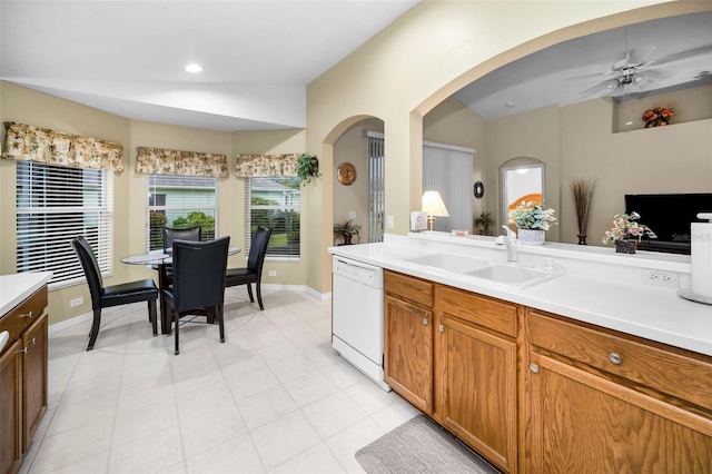 kitchen featuring white dishwasher, vaulted ceiling, ceiling fan, and sink