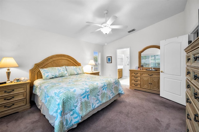 bedroom with ensuite bath, ceiling fan, lofted ceiling, and dark colored carpet