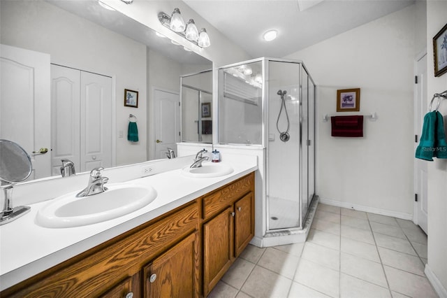 bathroom with tile patterned flooring, vanity, and a shower with shower door