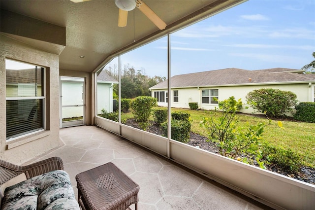 sunroom / solarium featuring ceiling fan