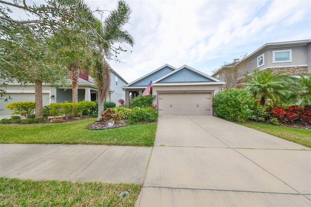 view of front of property featuring a front yard and a garage