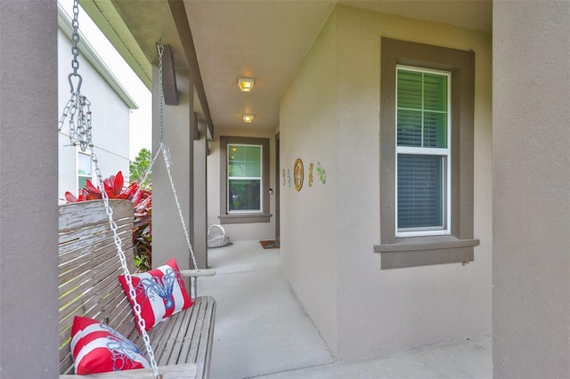 6516 Salt Creek Ave, Apollo Beach, FL 33572 - doorway to property with stucco siding and covered porch