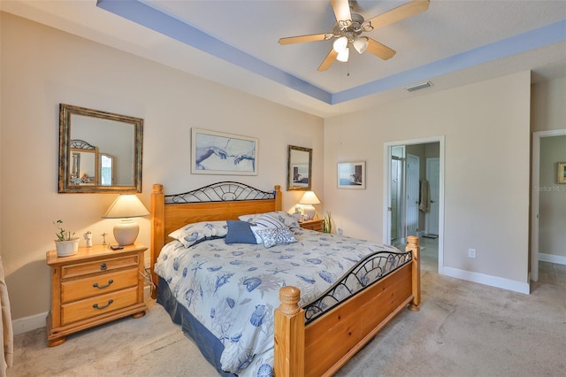 6516 Salt Creek Ave, Apollo Beach, FL 33572 - bedroom with light carpet, baseboards, ensuite bathroom, a ceiling fan, and a tray ceiling