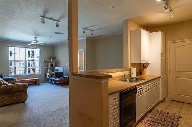 kitchen with dishwasher, kitchen peninsula, crown molding, and sink