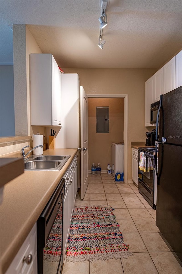 kitchen with sink, rail lighting, white cabinets, and black appliances