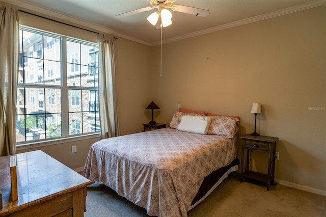 carpeted bedroom featuring multiple windows, ceiling fan, and crown molding