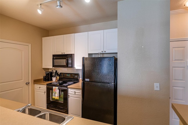 kitchen with sink, a textured ceiling, track lighting, white cabinets, and black appliances