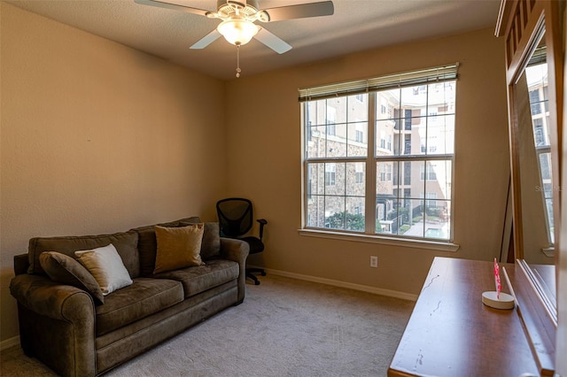 carpeted living room featuring ceiling fan