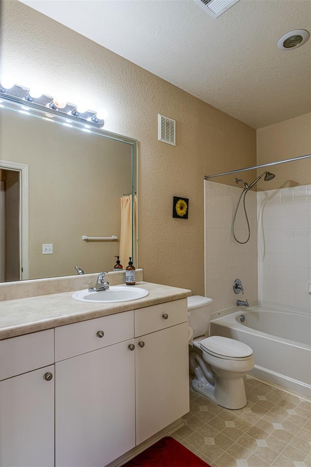 full bathroom featuring a textured ceiling, vanity, bathing tub / shower combination, and toilet