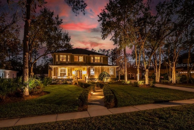 view of front of house featuring a yard and covered porch