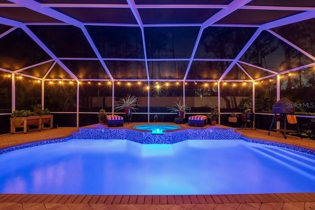 view of swimming pool with an in ground hot tub, a patio, and glass enclosure