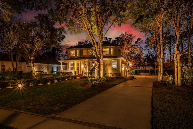 view of front of property with a lawn and covered porch