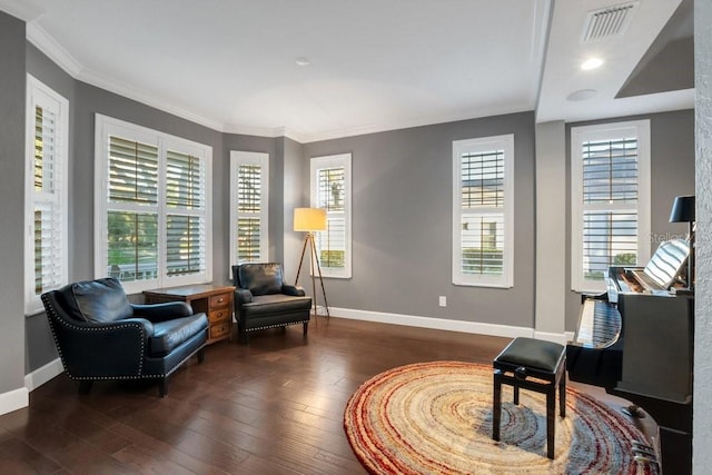 sitting room with ornamental molding and dark wood-type flooring