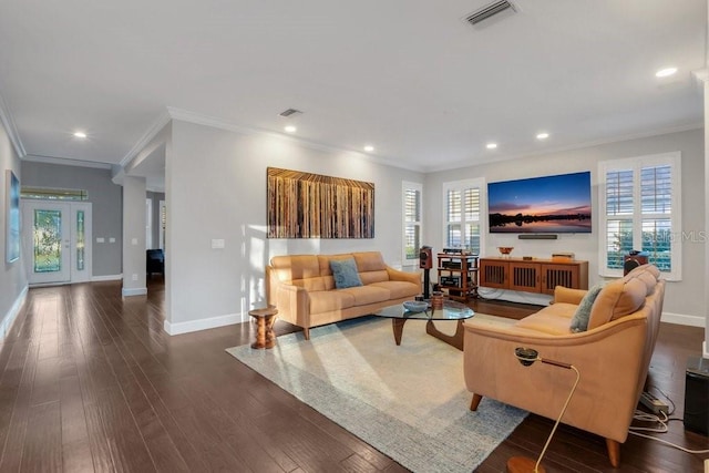 living room featuring plenty of natural light, dark hardwood / wood-style flooring, and ornamental molding