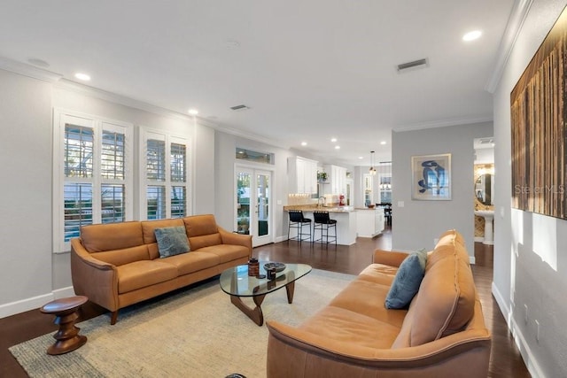 living room featuring crown molding, french doors, sink, and hardwood / wood-style flooring