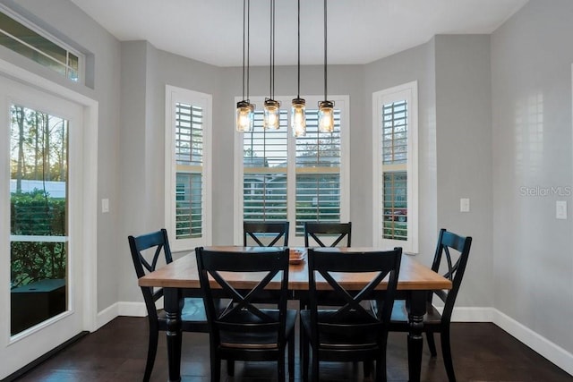 dining space with dark wood-type flooring