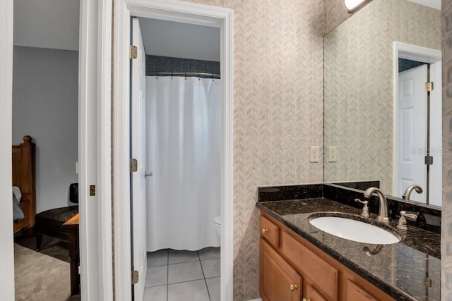 bathroom with toilet, tile patterned flooring, vanity, and a shower with shower curtain