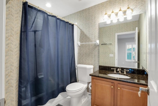 bathroom with tile patterned flooring, vanity, and toilet